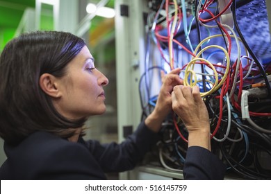 Technician Fixing Cable In Server Room