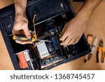 Technician fixing problem with PC Mid adult man, computer maintenance technician,top view close up photo