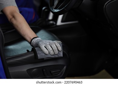 Technician with gloves cleaning the car dashboard with red cloth. Topical car wash and care. protection of the interior of the automobile. cleaning, health and care concept. - Shutterstock ID 2207690463