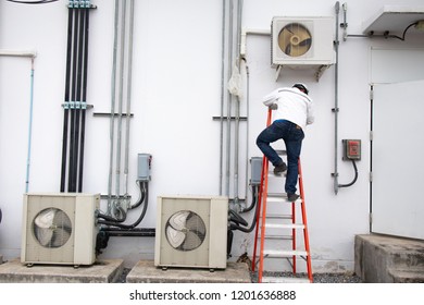 Technician Going Up The Ladder For Routiens Inspec And Repairing Air Conditioner (Condensing Unit).