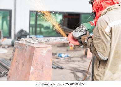 Technician grinding edge of steel to smooth steel after cutting with gas torch in an industrial. - Powered by Shutterstock