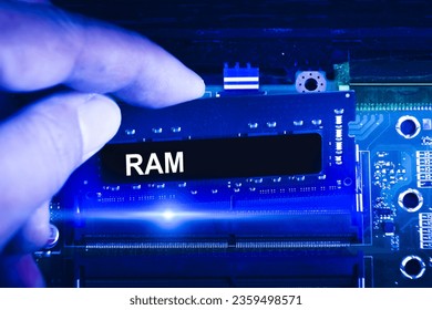 Technician hand insert RAM memory to memory slot on computer motherboard. Technician upgrade RAM memory into laptop. blue tone, Computer technology concept.