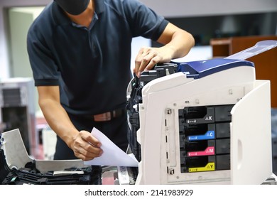Technician hand open cover photocopier or photocopy to fix paper jam and replace ink cartridges for scanning fax or copy document in office workplace. - Shutterstock ID 2141983929