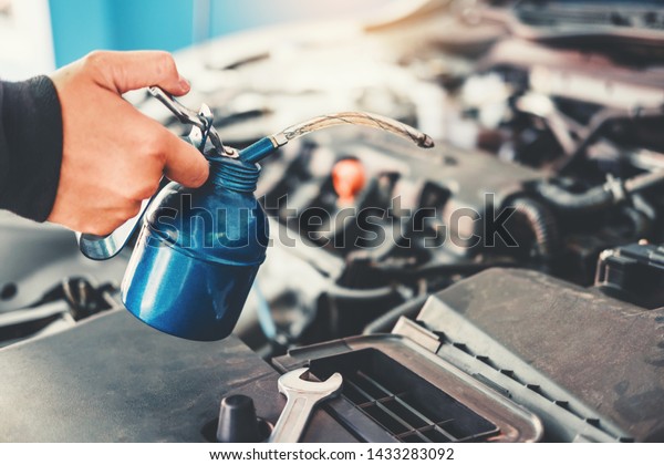 Technician Hands of car mechanic working\
in auto repair Service and Maintenance\
car