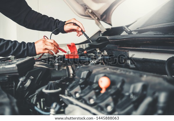 Technician Hands of car mechanic
working in auto repair Service and Maintenance car
battery