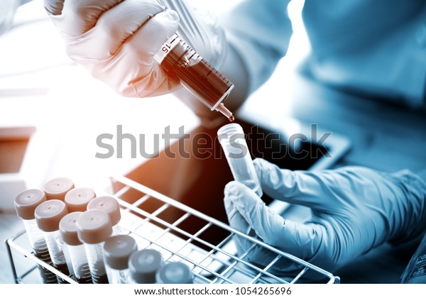 technician of health with test tubes in the\
clinical lab for analytical , Medical, pharmaceutical and\
scientific research and development\
concept.