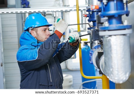 technician of heating system in boiler room