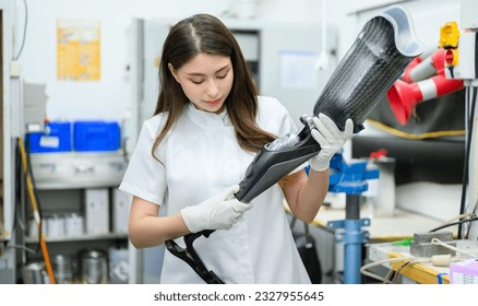 Technician holding prosthetic limb checking and working in laboratory - Powered by Shutterstock