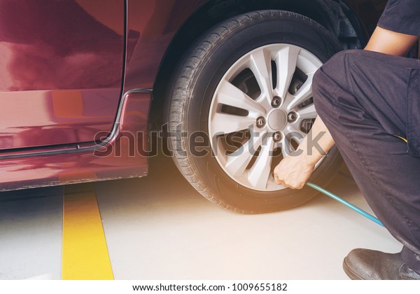 Technician is inflate car tire - car maintenance\
service transportation safety\
concept