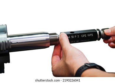 Technician inspecting industrial threaded plug gauge workpiece on white background
,industrial concept - Powered by Shutterstock