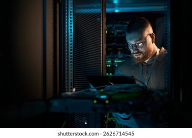 Technician Inspecting Server Hardware in Data Center