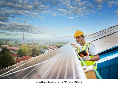 Technician Inspecting Solar Panel Maintenance On Hospital Roof, Solar Panel Maintenance View