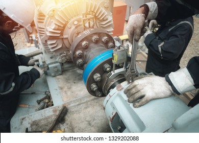 Technician inspector alignment pump  and electric motor, Repairing work in factory concept