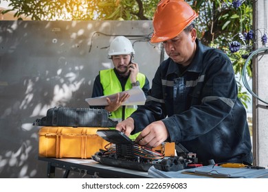 Technician are install fiber optic cable lines and Engineer are checking core assignment plan for maintenance. - Shutterstock ID 2226596083