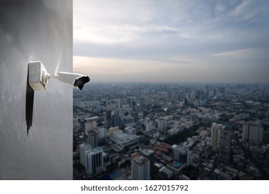 Technician Installed Wireless CCTV  Infrared Camera Technology 4.0 On The Building Wall By For Look Security Area Of Work With City Scape And Blue Cloud Sky Background.