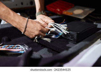 Technician installing the car audio processor Car audio installation concept.