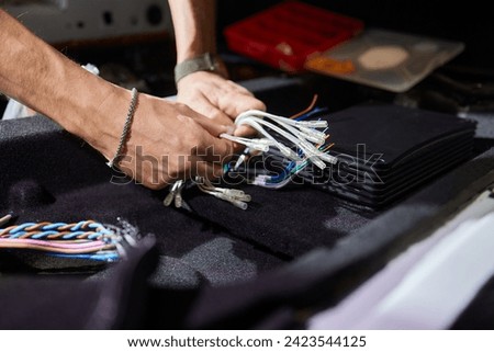 Technician installing the car audio processor Car audio installation concept.