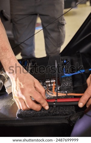 Technician installing the car audio processor Car audio installation concept.