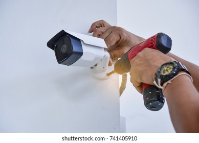Technician installing CCTV camera for security - Shutterstock ID 741405910