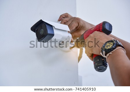 Technician installing CCTV camera for security