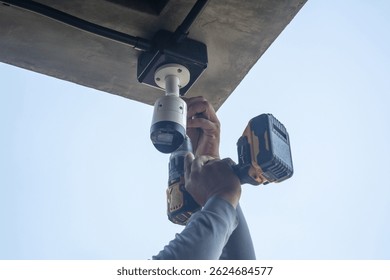 Technician installing CCTV camera system for security area