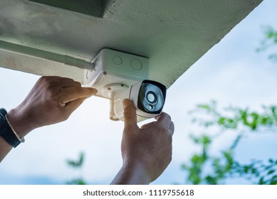 Technician Installing IP Wireless CCTV Camera By Screwed For Home Security System And Installed White Plastic Boxes For Safe From Water And Rain.