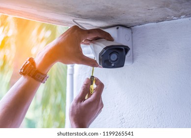 Technician Installing IP Wireless CCTV Camera By Screwed For Home Security System And Installed White Plastic Boxes For Safe From Water And Rain