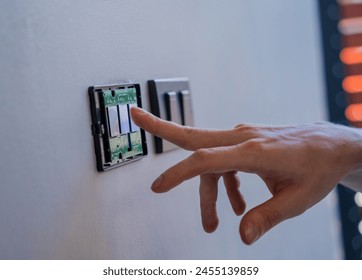 Technician installing sensor light switch at modern villa
