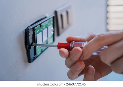 Technician installing sensor light switch at modern villa