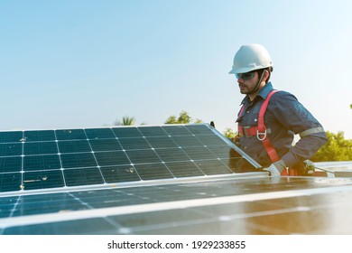 A technician installing the solar panels at roof top of home and home office ,concept of economic energy and cost saving ,own small business - Shutterstock ID 1929233855
