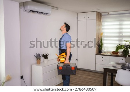 Technician looking and checking air conditioning unit with toolbox