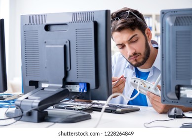 IT technician looking at IT equipment