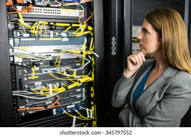Technician looking at open server locker at the data centre