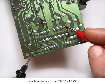 Technician making measurements on electronic circuit board.  - Powered by Shutterstock