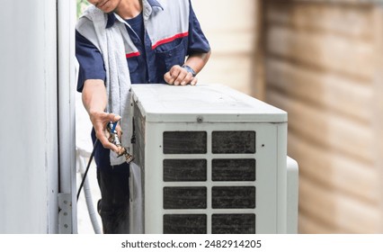 Technician man cleaned mold in the air conditioning system, Repairman washed dirty air conditioner, Maintenance and service concepts