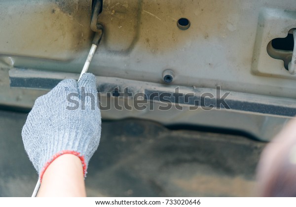 Technician man\
hands open bonnet and checking fixing engine of car.Car\
service.Mechanic hands checking up of serviceability of the car in\
open hood.Checking conditions\
concept.