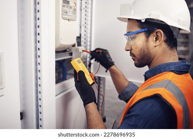 Technician, man and multimeter testing power for electricity, energy inspection and electrical system. Electrician, engineering and voltage test tool for machine, industrial mechanic and control room