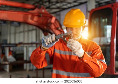 A Technician Mechanic Man Use Vernier Caliper And Holding Bulldozer Sprocket To Inspection And Repair Maintenance Heavy Machinery, Industrial Theme.