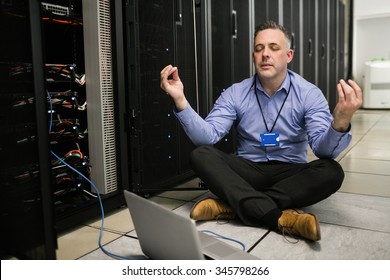 Technician meditating in server room at the data centre - Powered by Shutterstock