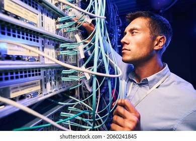 Technician Monitoring Fiber Optic Cables With Electronic Device