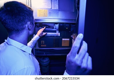 Technician Monitoring Power Supply System On Network Server