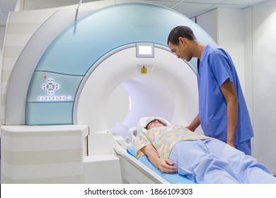 Technician Nurse Preparing A Patient For The MRI Scan In The Hospital