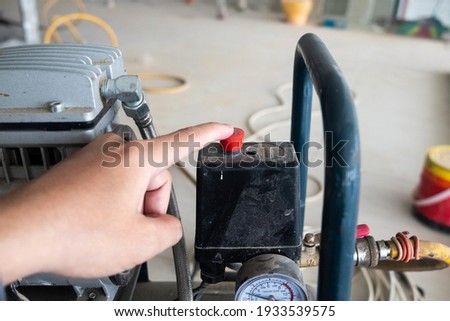 Technician operator push the compressor machine button.