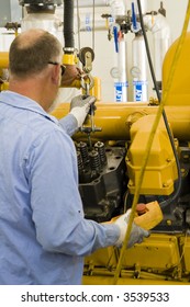 A Technician Performing Periodic Engine Maintenance In A Landfill Gas Recovery Plant