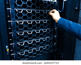 A technician performs maintenance on a server rack in a modern data center, focusing on optimal hardware setup and ensuring high performance and reliability.