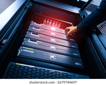 A technician performs server maintenance in a modern data center rack, ensuring optimal performance and connectivity for vital computing equipment. - Powered by Shutterstock - Get 15% off with code: PIKWIZARD15