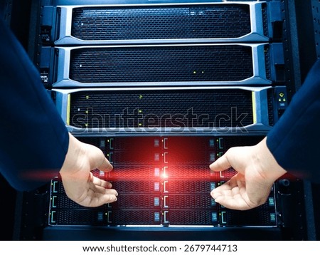 An IT technician performs server maintenance in a modern data center, showcasing the critical operation of managing hardware and network systems efficiently.