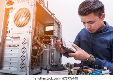 The technician put the Hard disk drive in the computer case. the concept of computer hardware, repairing, upgrade and technology.