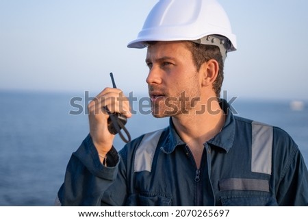 Technician with radio set near sea