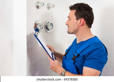 Technician Reading The Water Meter To Check Consumption